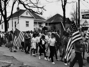 UNITED STATES - CIRCA 1965:  Participants, some carrying American flags, marching in the civil rights march from Selma to Montgomery, Alabama in 1965  (Photo by Buyenlarge/Getty Images)